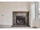 Modern stone fireplace with wood mantel at 10212 W 80Th Dr # D, Arvada, CO 80005