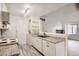 Galley-style kitchen with white cabinets and stainless steel appliances at 10212 W 80Th Dr # D, Arvada, CO 80005