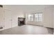 Living room featuring a fireplace and large windows at 10212 W 80Th Dr # D, Arvada, CO 80005