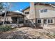 Charming backyard featuring a brick patio, covered porch, swing set, and well-maintained lawn perfect for outdoor living at 1482 S Lansing St, Aurora, CO 80012