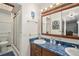 Bathroom with a blue countertop, double sinks, and a glass-enclosed shower at 1482 S Lansing St, Aurora, CO 80012