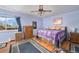 Primary bedroom with a light purple walls, wood floor, ceiling fan, and a large window at 1482 S Lansing St, Aurora, CO 80012