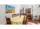Bright dining area with hardwood floors, large windows, and table that sits six people at 1482 S Lansing St, Aurora, CO 80012