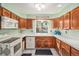 Bright kitchen features wood cabinets, white countertops, and a window over the sink at 1482 S Lansing St, Aurora, CO 80012
