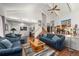 Open-concept living room with hardwood floors, neutral walls, dining area, and lots of space at 1482 S Lansing St, Aurora, CO 80012