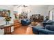 Cozy living room with hardwood floors, vaulted ceiling, and access to dining area at 1482 S Lansing St, Aurora, CO 80012