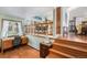 Office room with hardwood floors, natural light, view of the dining area, and neutral walls at 1482 S Lansing St, Aurora, CO 80012
