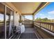 Cozy covered balcony features stylish outdoor seating, a charming table, and scenic views at 12762 Ironstone Way # 302, Parker, CO 80134