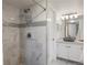 Bathroom featuring a glass door shower with marble tile and a matching vanity and sink at 12762 Ironstone Way # 302, Parker, CO 80134
