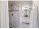 Modern bathroom featuring a tiled shower with glass door and elegant fixtures and a marble floor at 12762 Ironstone Way # 302, Parker, CO 80134