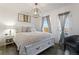 Cozy bedroom featuring a comfortable bed, soft lighting, and a peaceful view from the window at 12762 Ironstone Way # 302, Parker, CO 80134