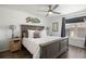 Comfortable bedroom featuring a queen-size bed, wood floors, neutral walls, and a ceiling fan at 12762 Ironstone Way # 302, Parker, CO 80134