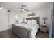 Comfortable bedroom with hardwood flooring, fan and ensuite bathroom at 12762 Ironstone Way # 302, Parker, CO 80134