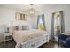 Cozy bedroom with a white bed frame, a plush blanket, wood floors, and a door to the balcony at 12762 Ironstone Way # 302, Parker, CO 80134