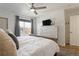 Bright bedroom featuring a ceiling fan, window, dresser, and a view from the window at 12762 Ironstone Way # 302, Parker, CO 80134