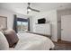 Bright bedroom featuring a window with neighborhood views, a ceiling fan, and a decorative dresser at 12762 Ironstone Way # 302, Parker, CO 80134