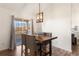Chic dining space features a modern light fixture and balcony access, perfect for enjoying meals with a view at 12762 Ironstone Way # 302, Parker, CO 80134