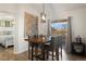 Dining room with wood table, upholstered chairs, modern light fixture, and patio doors at 12762 Ironstone Way # 302, Parker, CO 80134