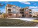 Multi-story condo building with brick accents, tan siding, private balconies and well-maintained lawn at 12762 Ironstone Way # 302, Parker, CO 80134