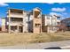 Well-maintained apartment complex with balconies and manicured lawn on a sunny day at 12762 Ironstone Way # 302, Parker, CO 80134