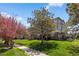 Beautiful building exterior with mature landscaping and lush lawn and sidewalks at 12762 Ironstone Way # 302, Parker, CO 80134