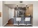 Eat-in kitchen featuring modern appliances, stylish cabinetry, and sleek countertops with barstool seating at 12762 Ironstone Way # 302, Parker, CO 80134