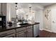 Kitchen island with sink and views to living room at 12762 Ironstone Way # 302, Parker, CO 80134