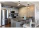 Modern kitchen with gray cabinets, stainless steel appliances, and an island with bar seating at 12762 Ironstone Way # 302, Parker, CO 80134