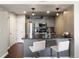 Contemporary kitchen with stainless steel appliances, gray cabinetry, and a breakfast bar, perfect for casual dining at 12762 Ironstone Way # 302, Parker, CO 80134