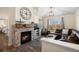 Inviting living room featuring a stone fireplace, TV, and a comfortable leather couch with neighborhood views at 12762 Ironstone Way # 302, Parker, CO 80134