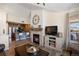 Open-concept living room with fireplace, shiplap wall, and kitchen area at 12762 Ironstone Way # 302, Parker, CO 80134