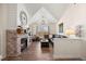 Comfortable living room with vaulted ceiling, modern gas fireplace, and a large leather sectional sofa at 12762 Ironstone Way # 302, Parker, CO 80134