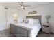 Tranquil main bedroom features a gray headboard, modern fan, and a door to ensuite bath at 12762 Ironstone Way # 302, Parker, CO 80134