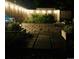 Night view of a backyard garden with raised planters and a stone path at 1360 S Hudson St, Denver, CO 80222