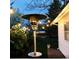 Cozy backyard with a patio heater, string lights, and manicured lawn at 1360 S Hudson St, Denver, CO 80222