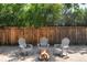 Backyard with Adirondack chairs around a fire pit and a wooden fence at 1360 S Hudson St, Denver, CO 80222