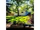 Lush backyard featuring mature trees, a well-manicured lawn, and a wooden fence for privacy at 1360 S Hudson St, Denver, CO 80222