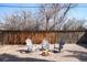 Backyard area with a gravel base and outdoor seating arranged around a fire pit at 1360 S Hudson St, Denver, CO 80222