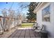 Cozy backyard patio with pavers, seating, string lights, and well-maintained landscaping in a fenced yard at 1360 S Hudson St, Denver, CO 80222