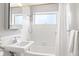 Bright bathroom with a vintage style vanity, shower and white subway tile at 1360 S Hudson St, Denver, CO 80222