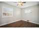 Bright bedroom with hardwood floors, ceiling fan, and two windows with blinds at 1360 S Hudson St, Denver, CO 80222