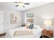 This bedroom features a ceiling fan, natural light, hardwood floors, and stylish decor at 1360 S Hudson St, Denver, CO 80222
