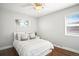 Cozy bedroom with large windows, hardwood floors, and a ceiling fan at 1360 S Hudson St, Denver, CO 80222