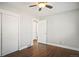 Bedroom with hardwood floors, closet, and open doorway at 1360 S Hudson St, Denver, CO 80222