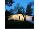 Inviting home exterior featuring illuminated landscaping and a well-manicured lawn at 1360 S Hudson St, Denver, CO 80222