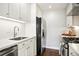 Bright kitchen features white cabinets, stainless steel appliances, subway tile backsplash, and modern faucet at 1360 S Hudson St, Denver, CO 80222