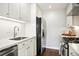 Well-lit kitchen boasts stainless steel appliances, white cabinets, and sleek countertops at 1360 S Hudson St, Denver, CO 80222