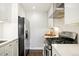 Modern kitchen with stainless steel appliances, white cabinets, and sleek countertops at 1360 S Hudson St, Denver, CO 80222