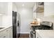 Sleek kitchen showcasing stainless steel appliances, white cabinets, and marble countertops at 1360 S Hudson St, Denver, CO 80222