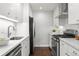 Modern kitchen featuring white cabinetry, stainless steel appliances, and a sleek backsplash at 1360 S Hudson St, Denver, CO 80222